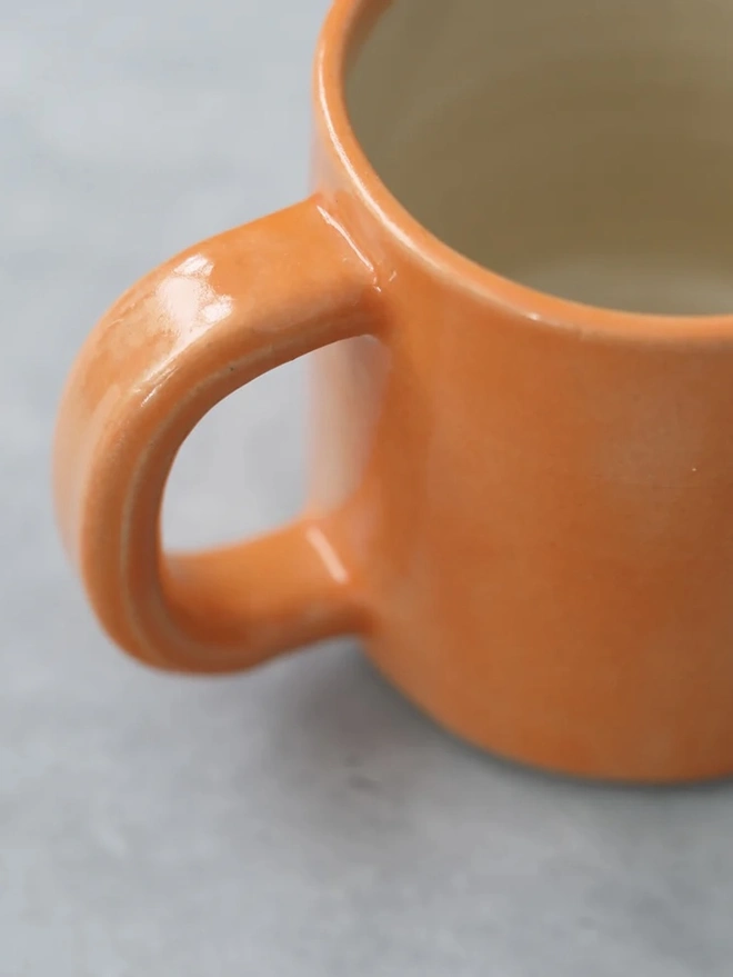 Ceramic Pint Mug, a colourful ceramic mug sitting on a white surface against a plain backdrop. 