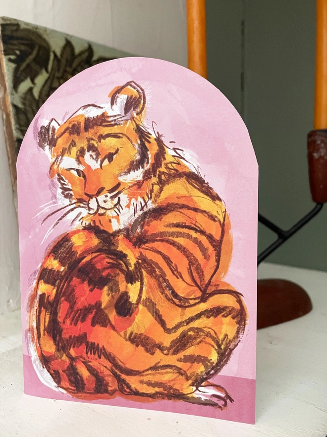 Esther kent illustrated arch-shaped greetings card, showing brown and orange tiger on a pink background