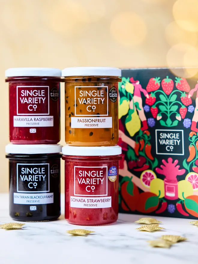 high fruit preserves in front of Christmas illustrated gift box