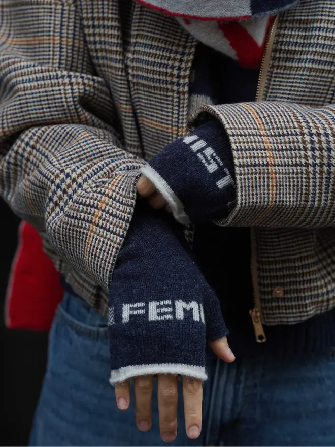 Lifestyle image of Prussian Blue & Clay Feminist Mittens worn with a tweed jacket