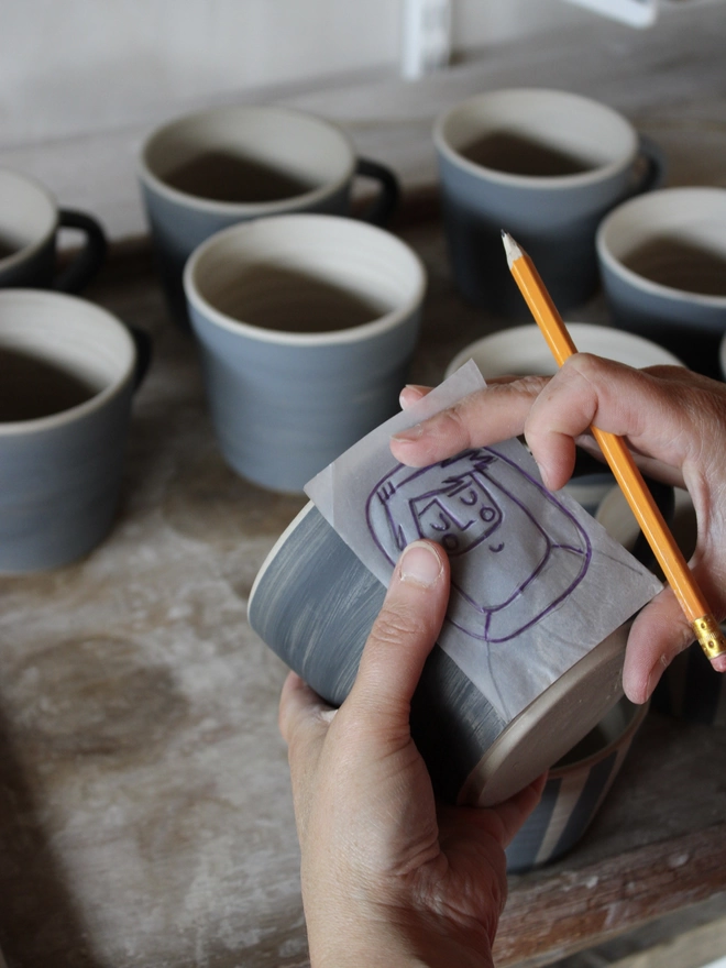 Laura Lane Ceramics sgraffito decorating a mug