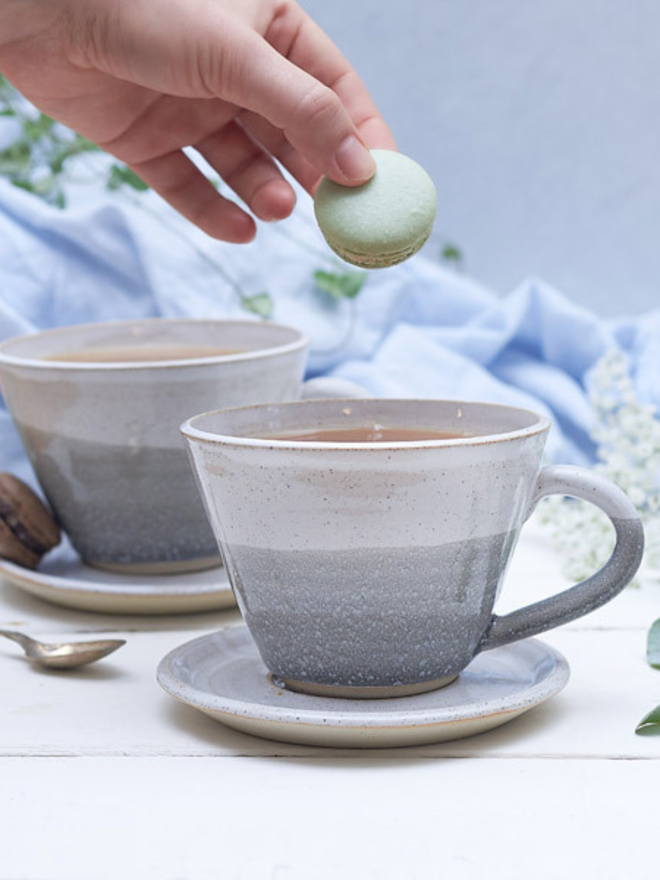 grey and white ceramic mug and saucer