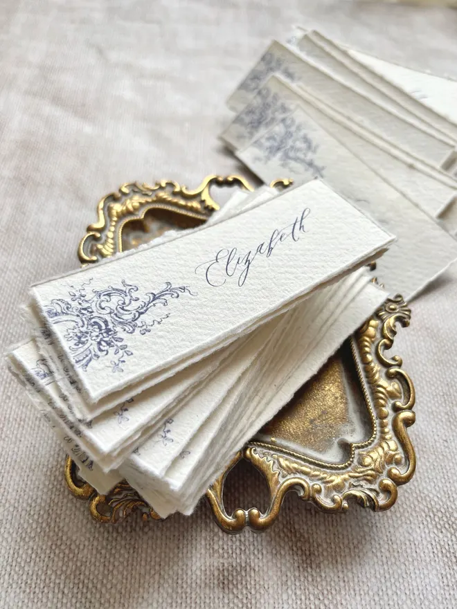 Long rectangular handmade paper place cards with blue print