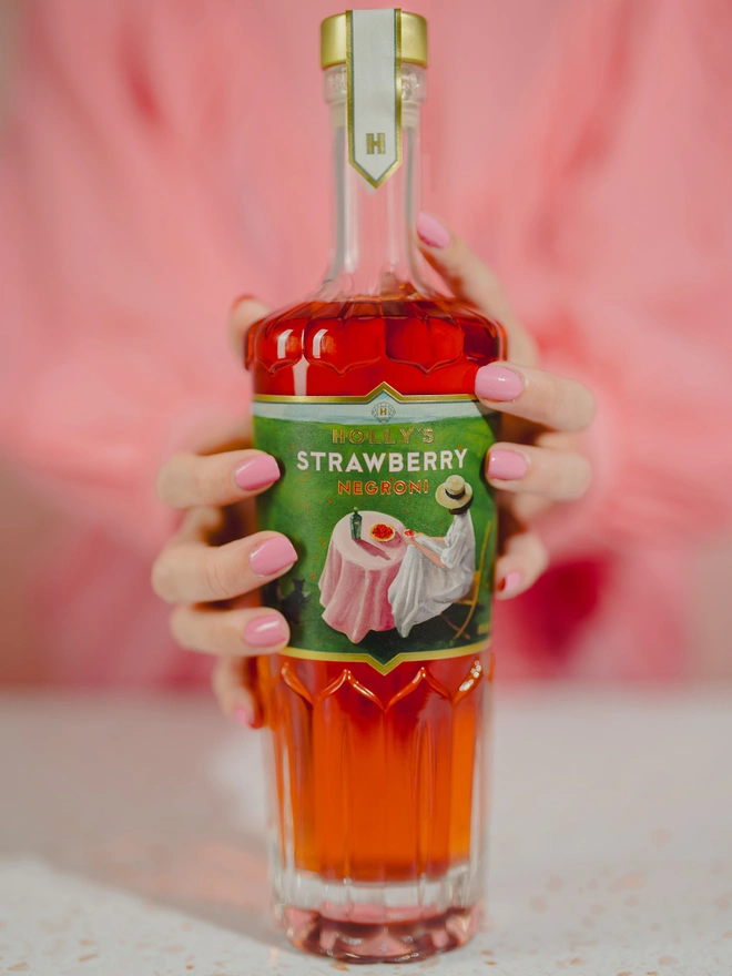 Holly holding her Strawberry Negroni Bottle