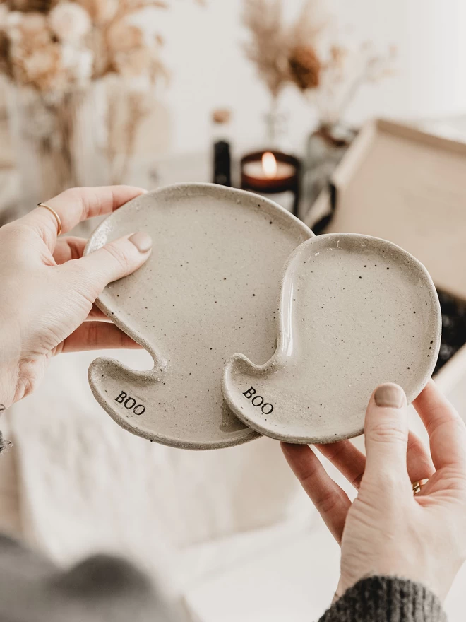 hands holding a set of ghost plates 