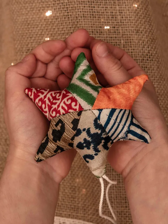 Upcycled Christmas Star decoration in hands