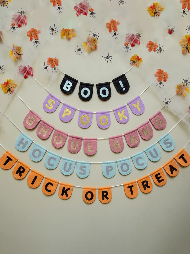 cute halloween scalloped bunting in a range of designs and colours. Options are "BOO!", "SPOOKY", "GHOUL GANG", "HOCUS POCUS" and "TRICK OR TREAT"