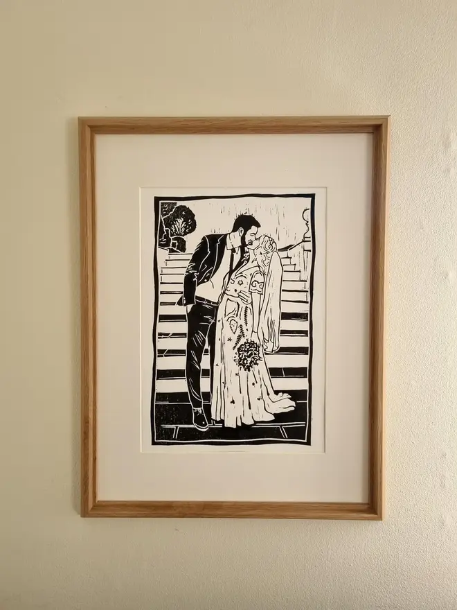 Personalised Handcrafted Linoprints, linoprint of romantic couple framed on a wall. 
