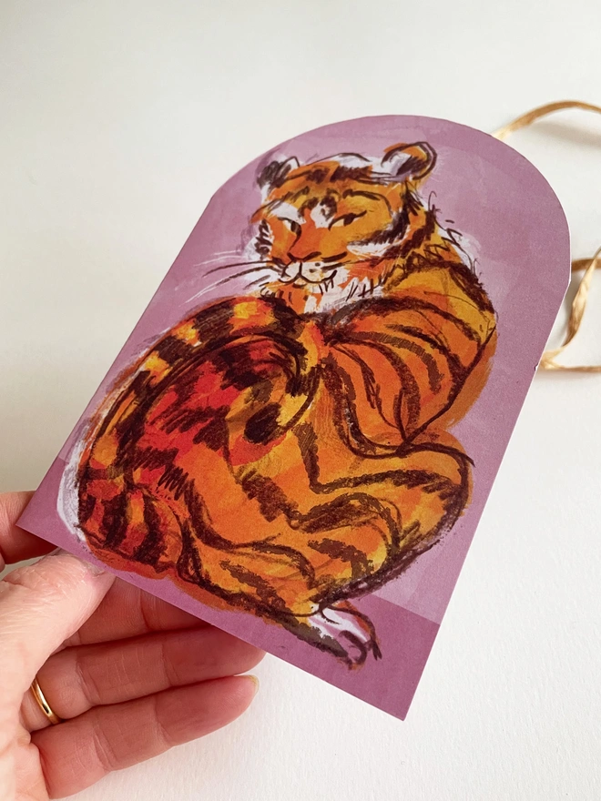 Esther kent illustrated arch-shaped greetings card, showing brown and orange tiger on a pink background