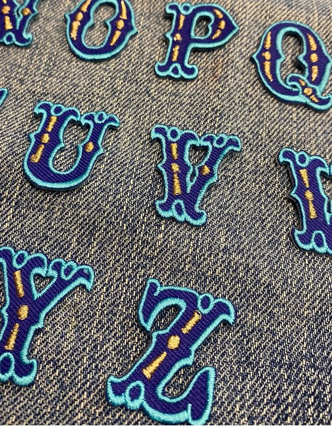 Blue alphabet iron on embroidered patch for personalising accessories and clothes.
