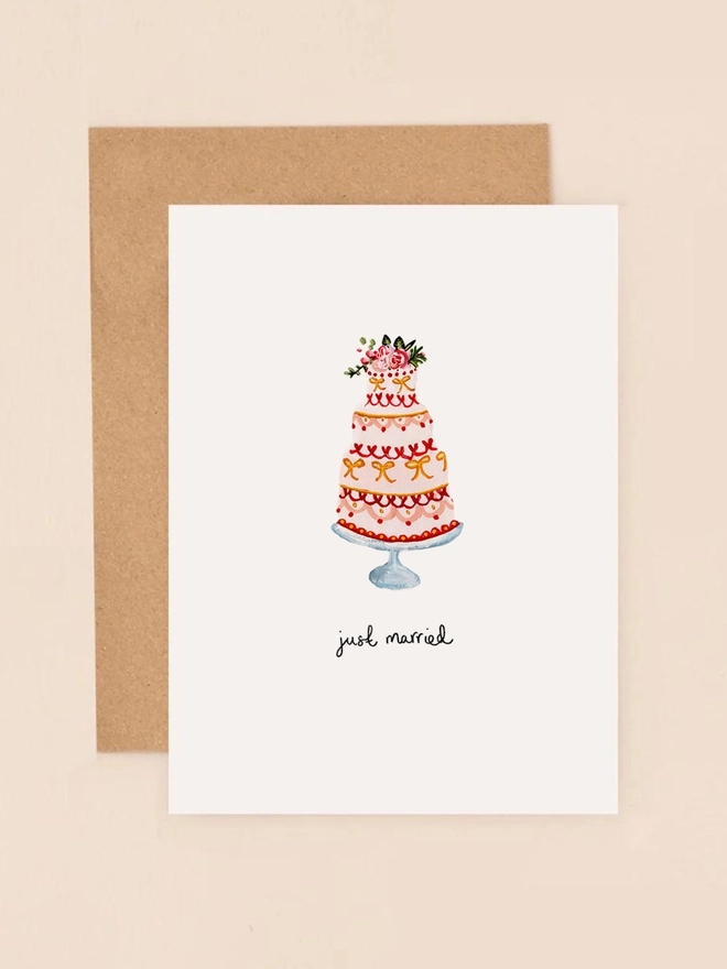A charming illustration of a tiered wedding cake adorned with delicate floral accents and a "Just Married" hand written message. The design captures the joy and elegance of a wedding celebration, making it a perfect choice for sending heartfelt congratulations to newlyweds.
