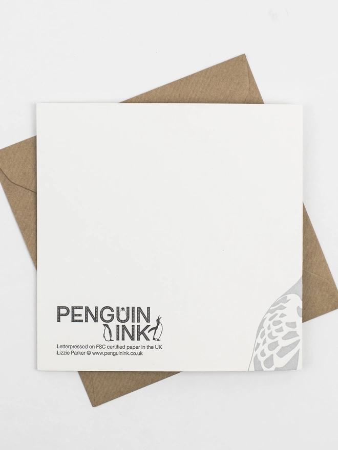 Back of the card that has the penguin Ink logo and one of the turtle doves feathers