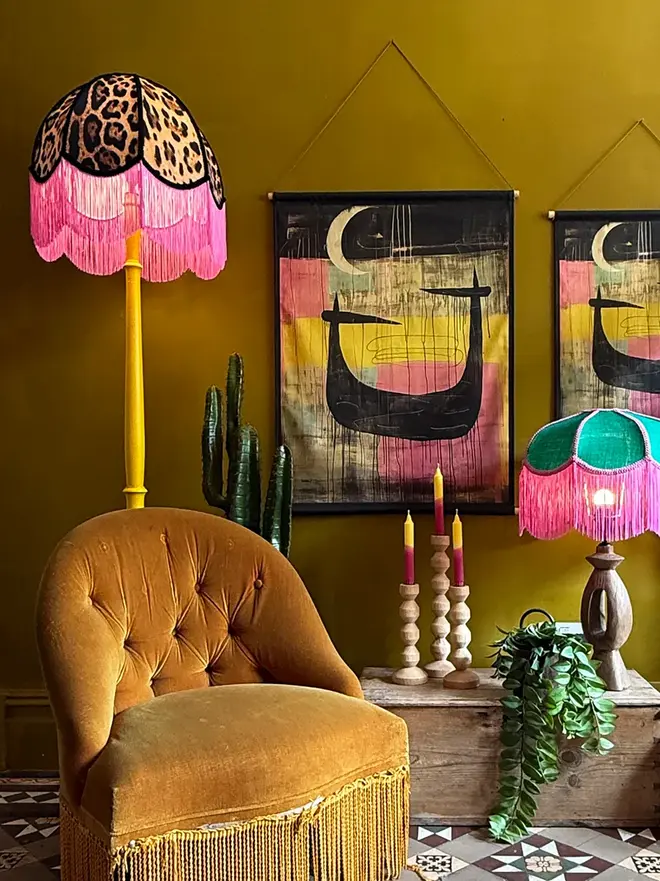 Vintage Fringed Lampshade in Leopardess With Pink Fringe, in a room. 