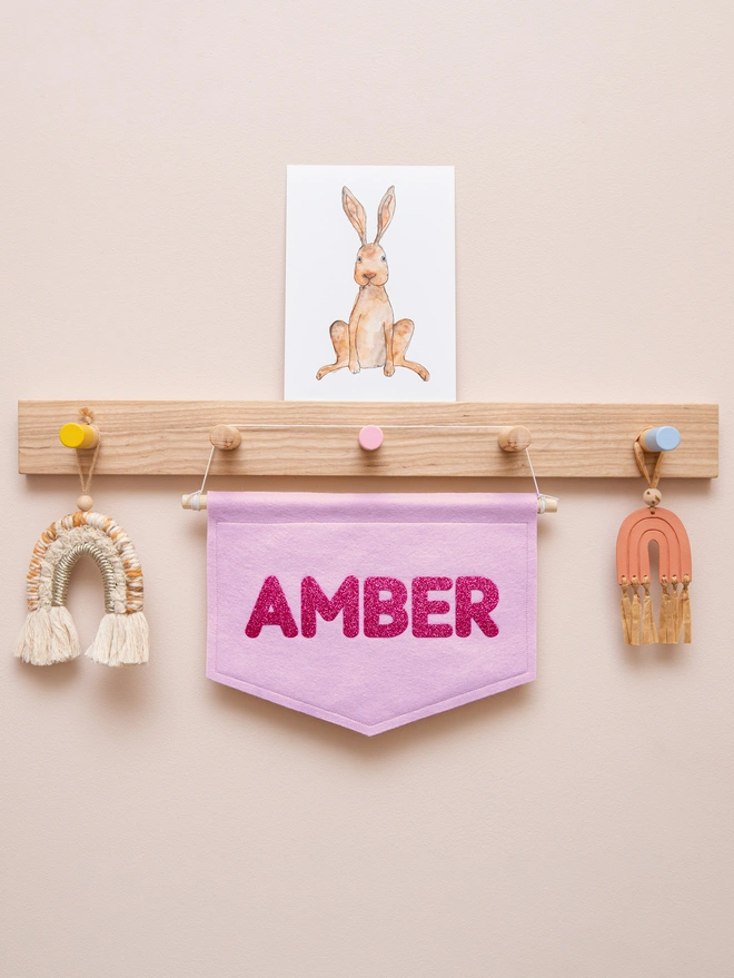 personalised felt name banner in mauve and glittery pink.