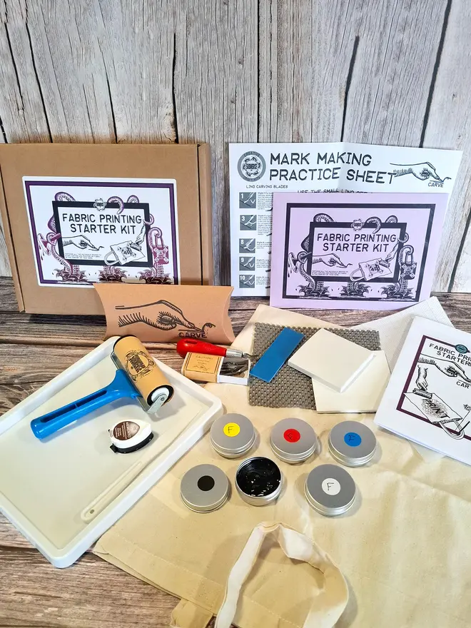 Fabric printing kit unpacked showing fabric roller fabric kinks carving tools tote bag and instructions