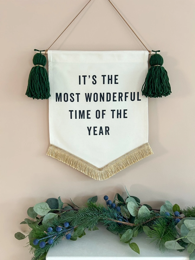 It's the most wonderful time of the year fabric christmas banner with dark green tassels and gold fringe trim
