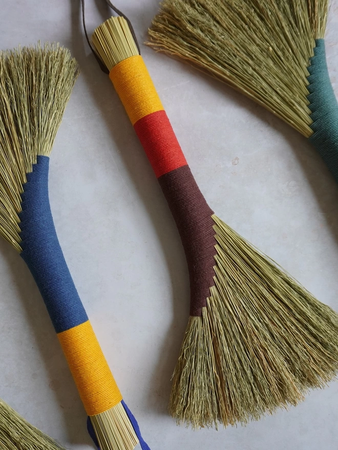 Broomcorn handbrooms in a variety of bright colours