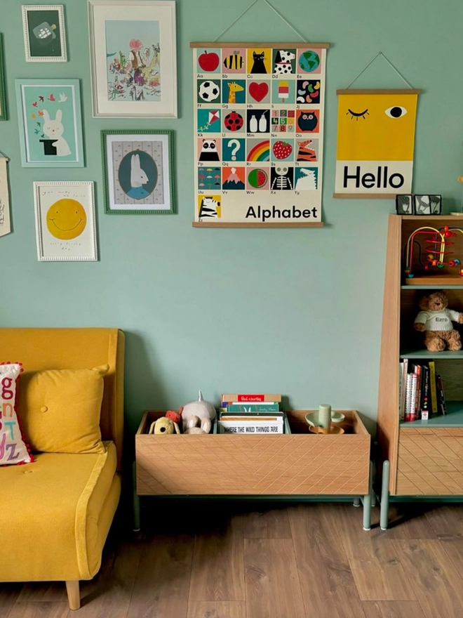 bold yellow wall print with word Hello hanging on a nursery wall