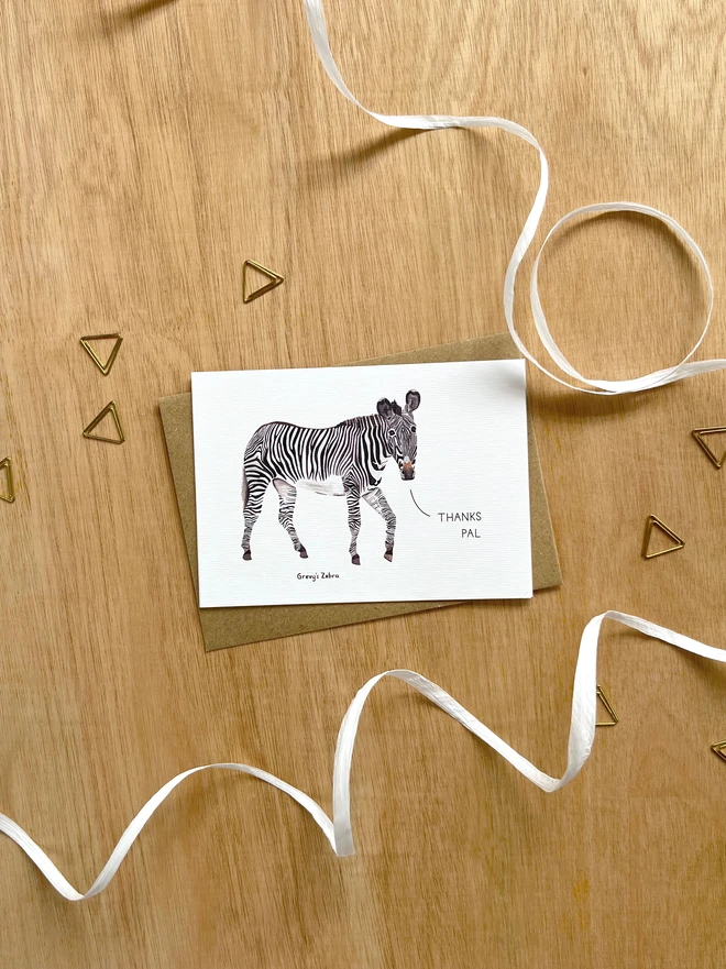 a greetings card featuring an illustration of a zebra with the text “thanks pal”
