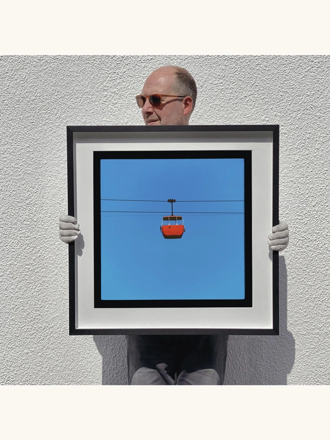 Richard Heeps holding Cable Car Red Framed in Black