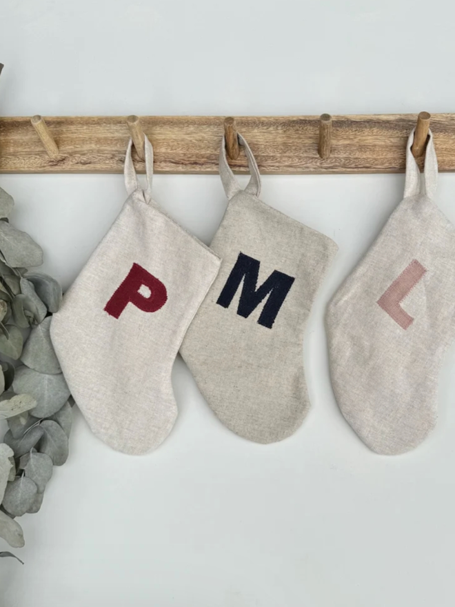 Stocking with Linen Initial. A selection of linen stockings with multicoloured initials.