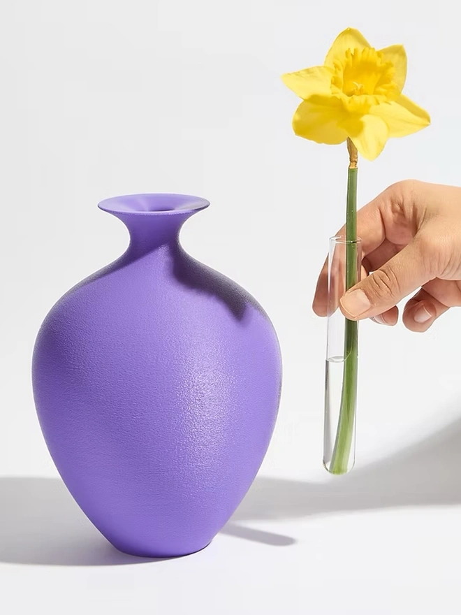 round urn shaped 3d printed vase in purple with yellow flower
