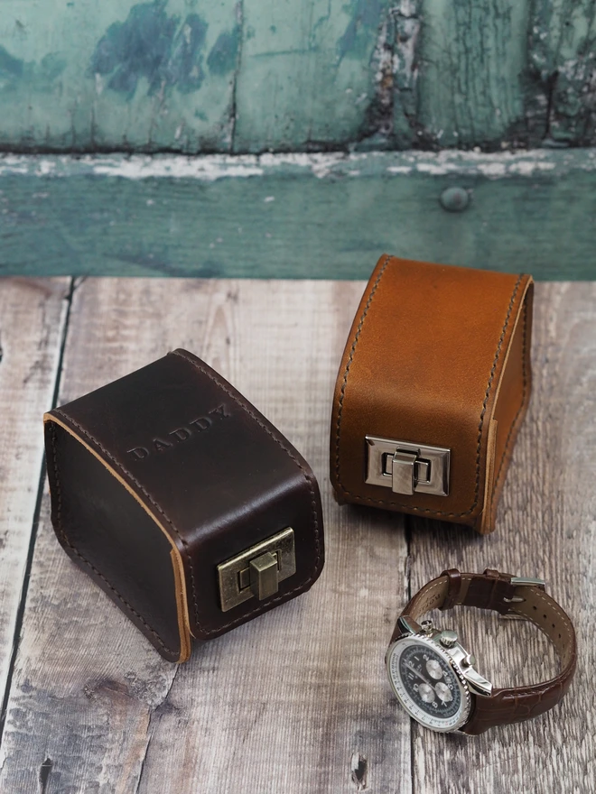 Personalised Leather Watch Case. Two leather watch boxes sit together, one is personalised with the name DADDY across the top of the case.