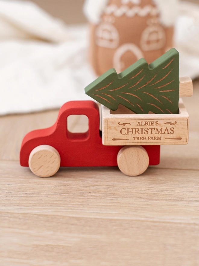 wooden Christmas truck toy in red with a green tree