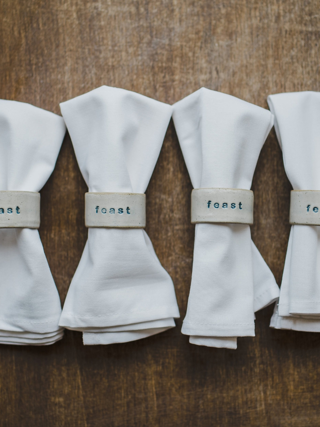 feast napkin ring on white napkin