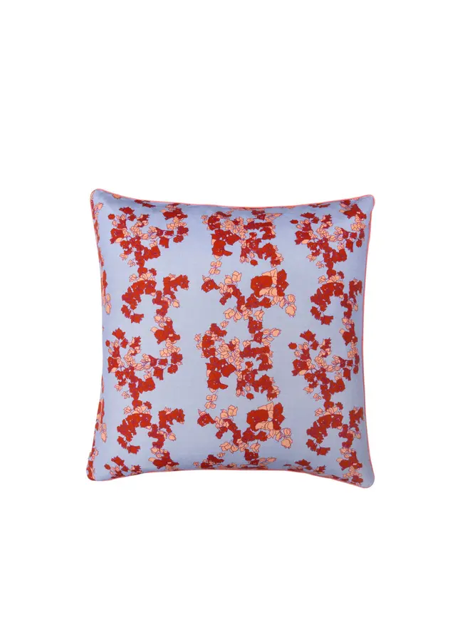 blue floral cushion on blank background