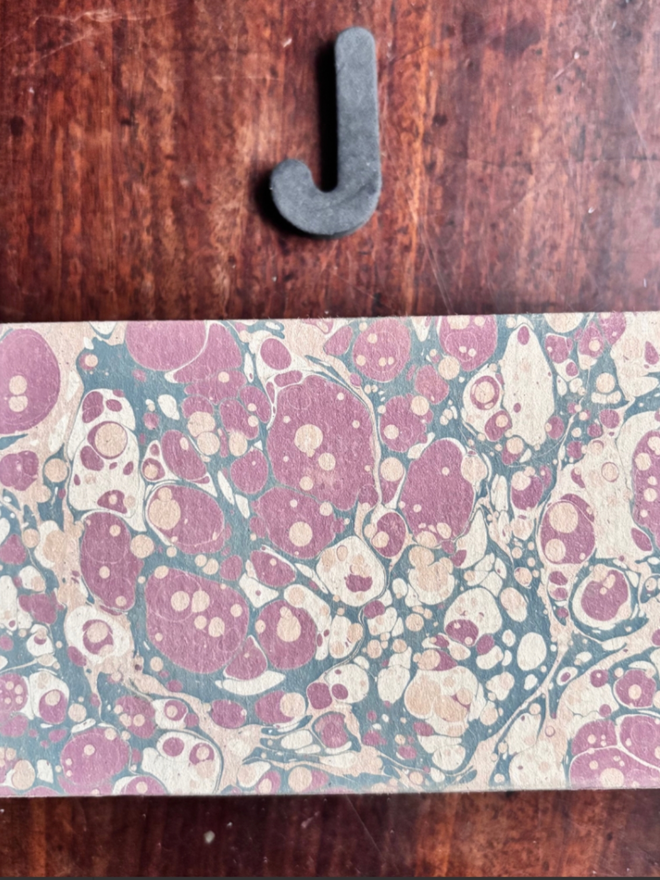 Matchbox Cover. A matchbox cover in J