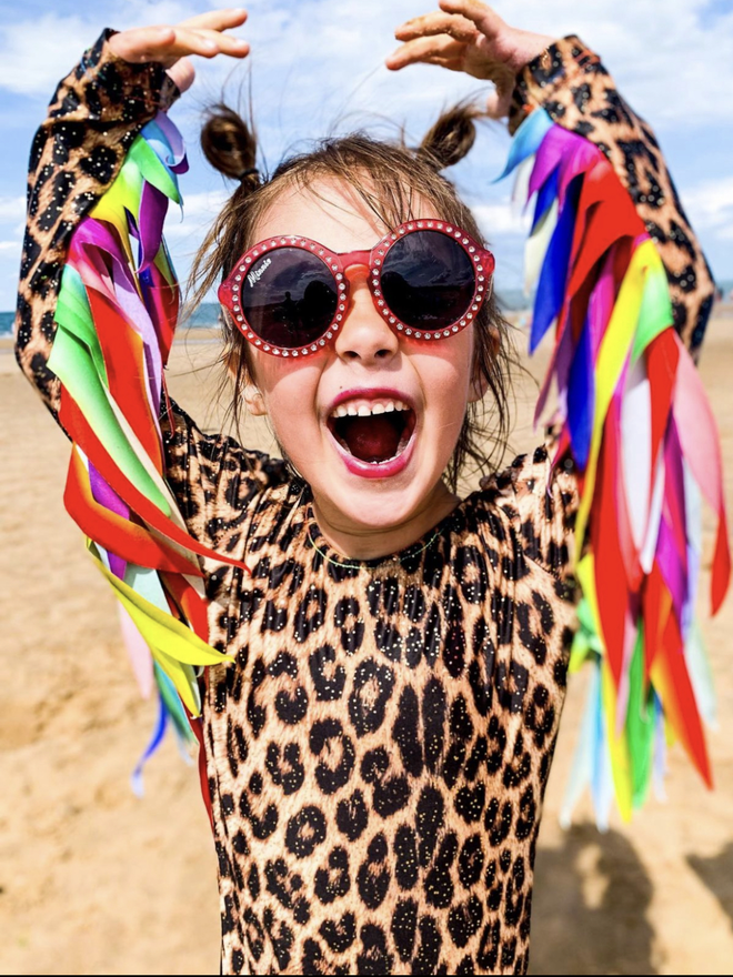 childrens leopard print leotard with gold galaxy dust. Long sleeves and Rainbow feather effect wings