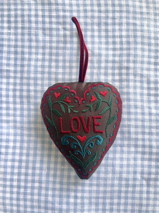 "LOVE" heart silk ornament with hearts, leaves and a scalloped edge (Dark green silk with red, green, and blue thread with a red ribbon)