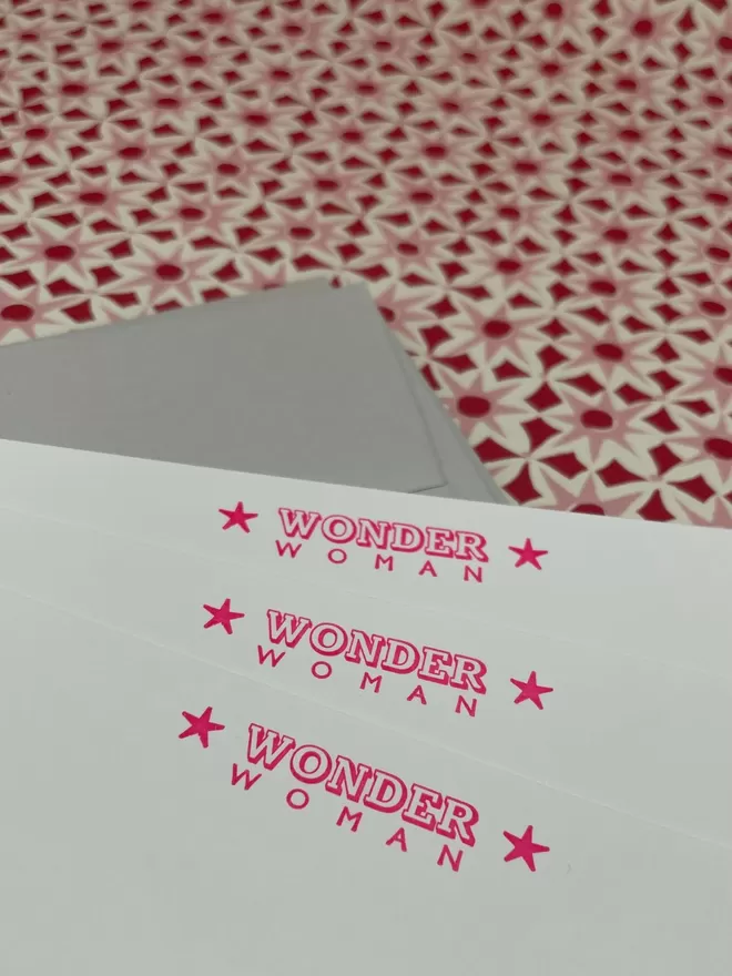 South London Letterpress Wonder Woman notecards in neon pink seen close up.