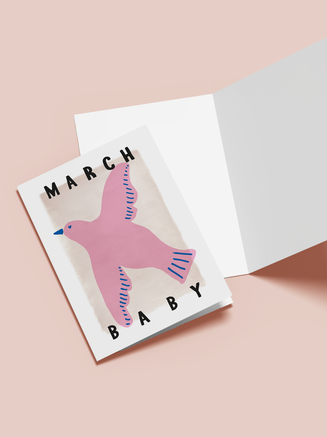 'march baby' illustrated card. a beige card with a pink illustrated bird in the centre.