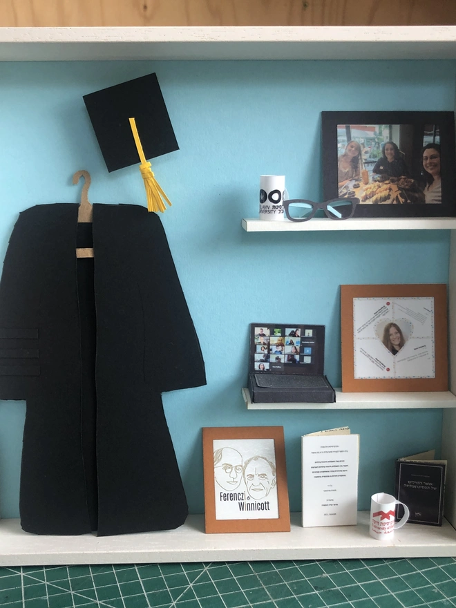 a wooden box with miniatures of the person favourite things inside. Each piece is handmade specially on request. bespoke art piece made by My Papercut Forest