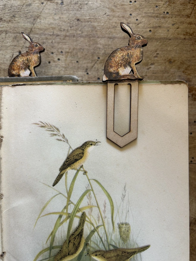 Sitting hare birch plywood paperclip bookmark attached to paper