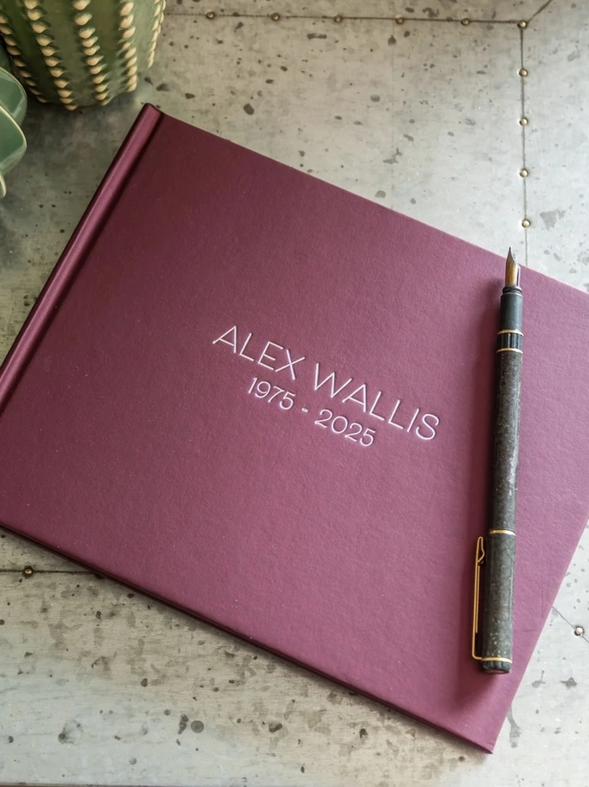 Sleek And Stylish Personalised Condolence Book on a table.