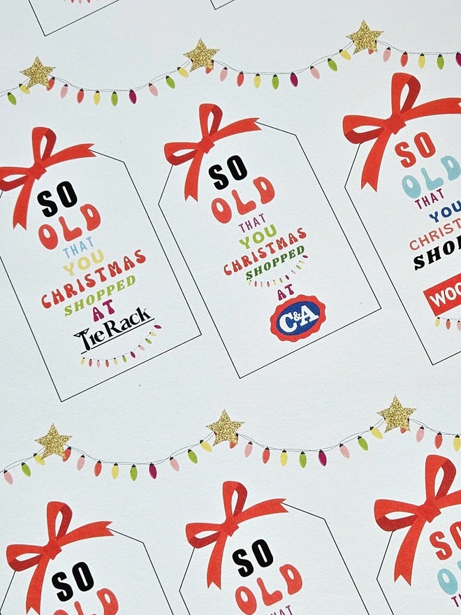 A close up photograph of the wrapping paper with tags that say so old you Christmas shopped at Woolworths, Tie Rack, C&A
