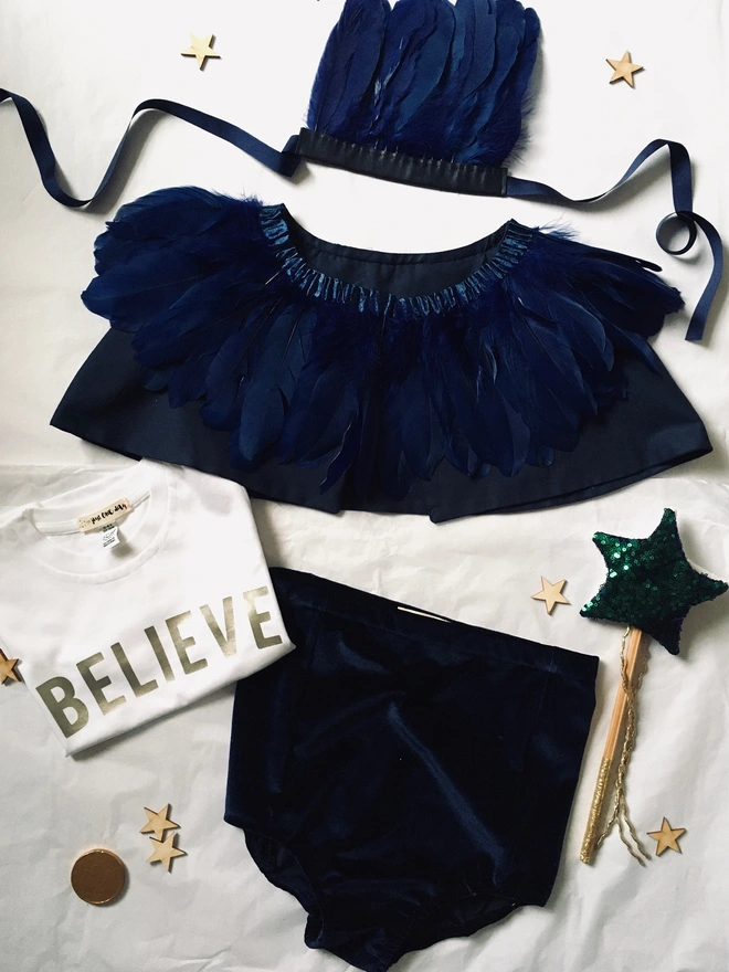 Navy blue feather cape, feather headdress, high waist shorts, believe t- shirt and star wand