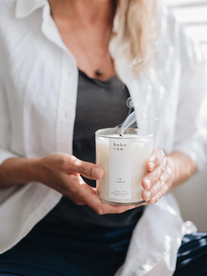 fig an cassis large candle blown out held in hands