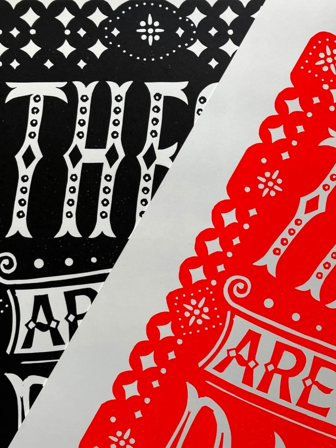 these are the days linocut. a linocut phrase printed on red and black paint.