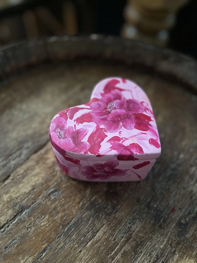 A beautifully hand painted floral ceramic heart shaped jewellery/ keepsake box background painted in a pale pink and pink peony flowers inspired by Toile De Jouy.