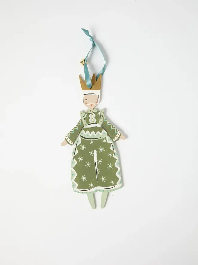 Prince Tree Dancer. wooden hanging prince decoration with a gold crown, sage green robe with white star and diamond patterning, duck egg blue ribbon with a jingle bell, on a white background