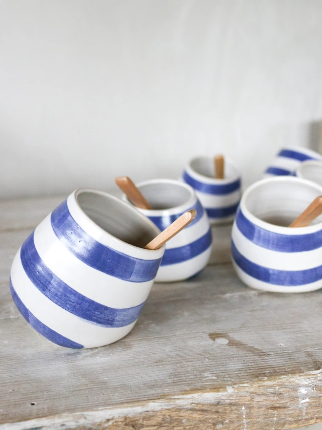 A collection of Cornish stripe salt pots