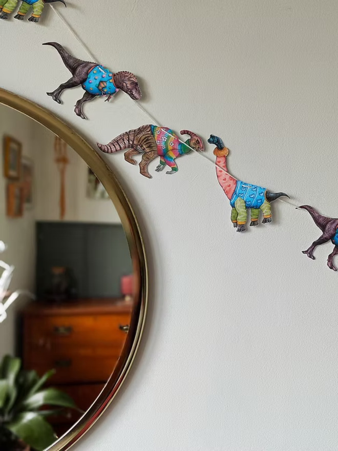 illustrated dinosaur garland. dinosaurs wearing jumpers on bunting.