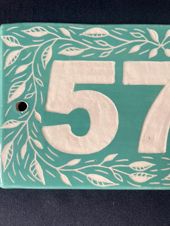Personalised Ceramic House Number Leaf Tile. A tile in turquoise.