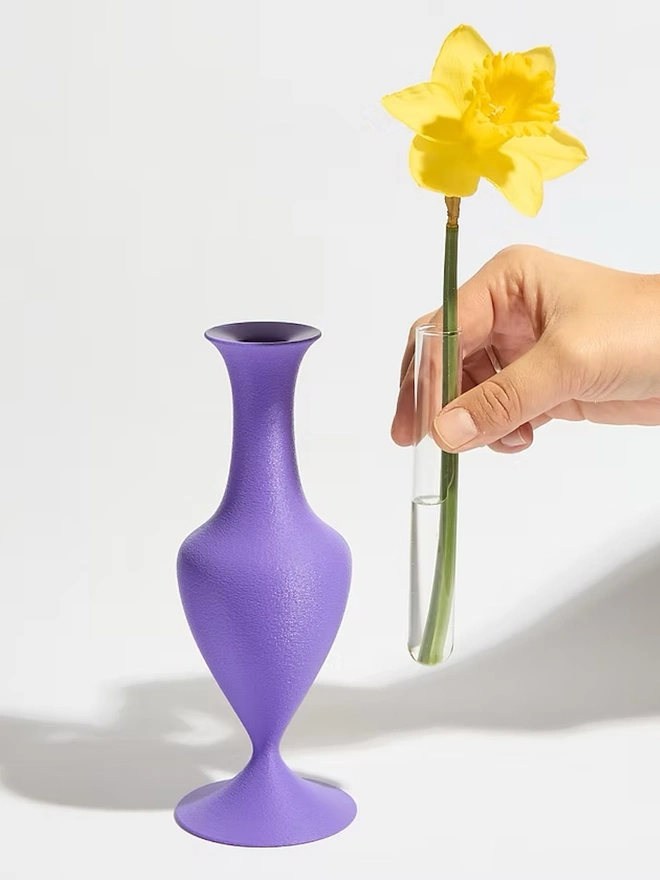 curvy shaped 3d printed vase in purple with yellow flower