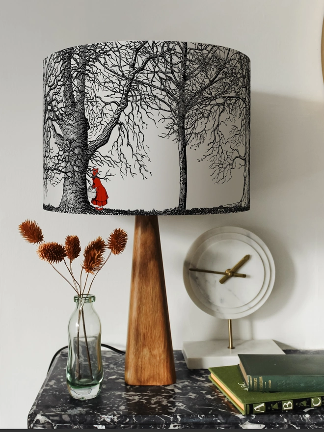 Handmade drum lampshade featuring a whimsical Little Red Riding Hood inspired design with a red cape, big bad wolf, and dark woodland scene.