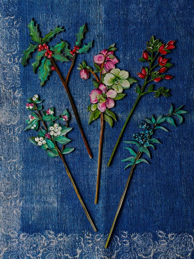 A group shot of different hand painted wooden plants